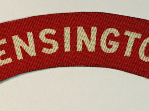 KENSINGTON – 13th London Regiment (Princess Louise’s Kensington Regiment) WW2 Printed Shoulder Title Badge – CALICO PRINTERS- Scarce — Lot No. 4339 - Image 2