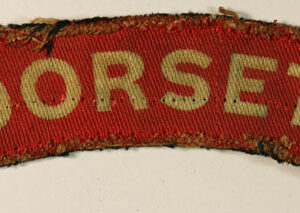 DORSET WW2 Printed Shoulder Title Badge - CALICO PRINTERS  ---  Lot No. 6241